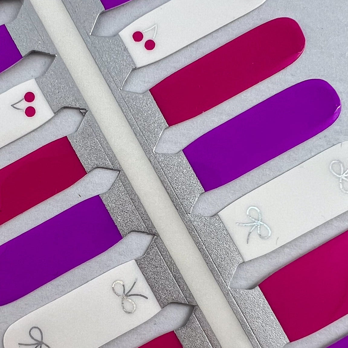 Detailfoto van nagelstickers met strikjes en kersjes voor kids op witte achtergrond